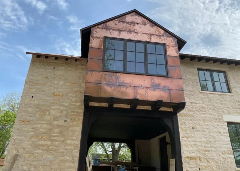 Copper metal panel facade on a stone building for Metal Roof Coating in Gentry