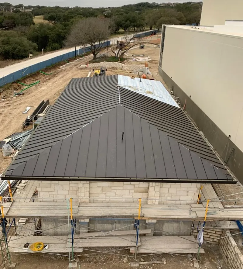Metal roof new construction with scaffolding in Gentry
